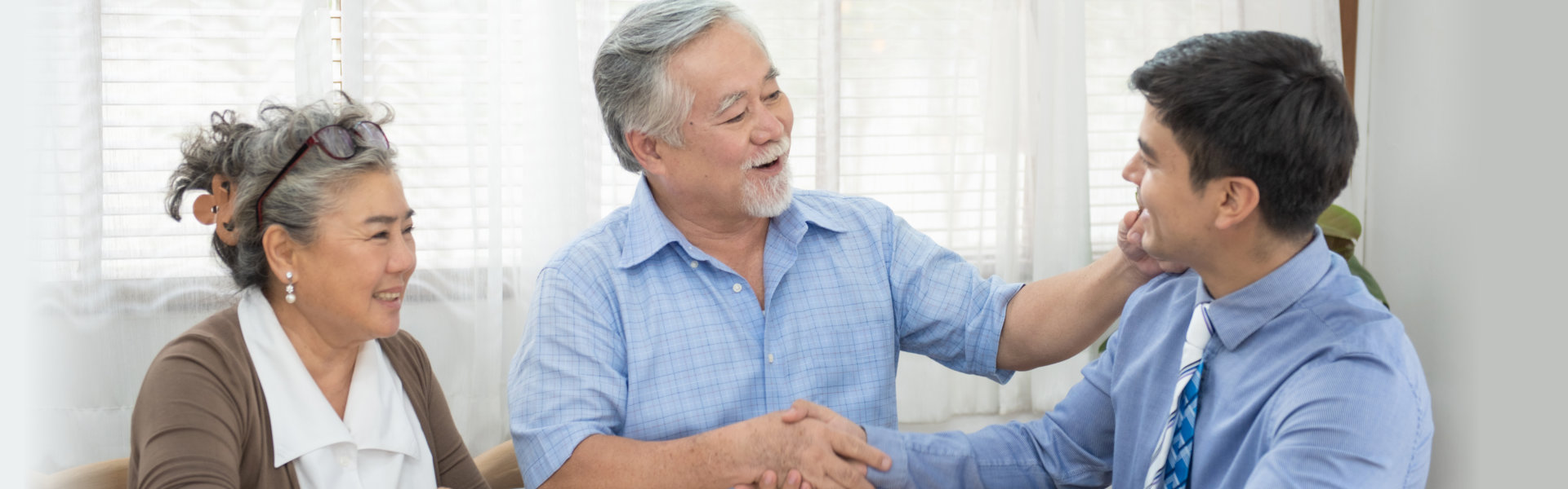 elderly couple talking to a financial advisor