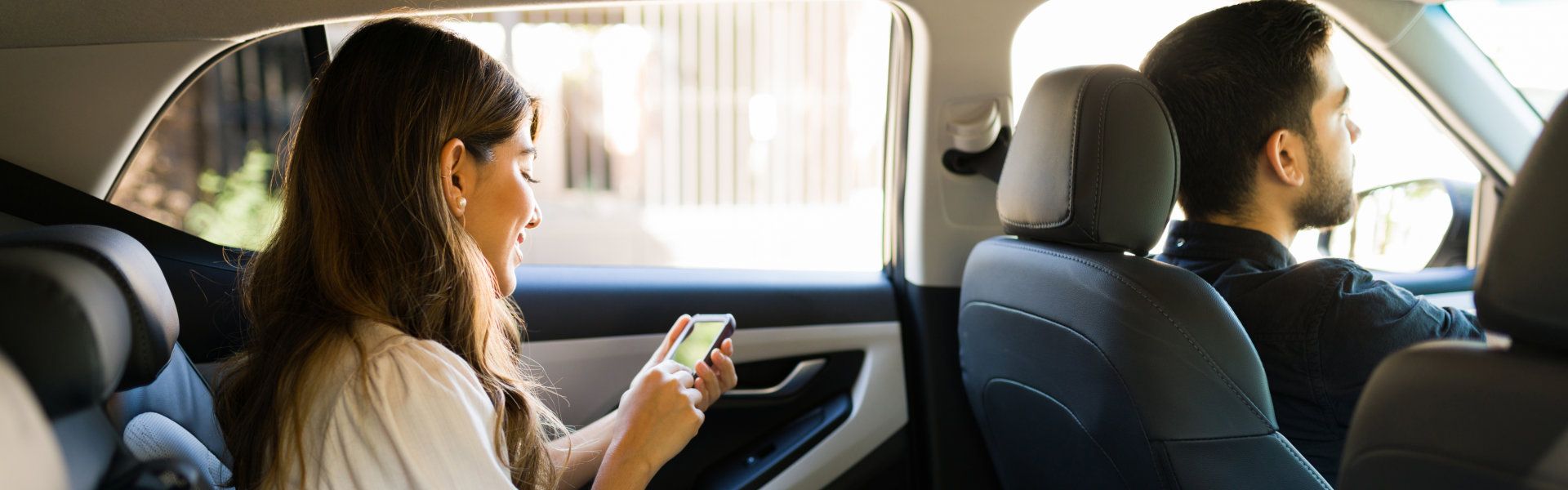 women sitting on the car back seat